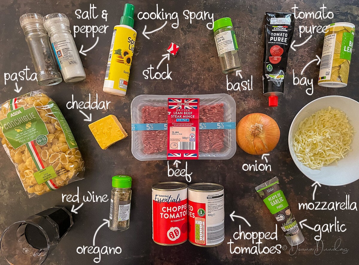 Ingredients for bolognese pasta bake on table.