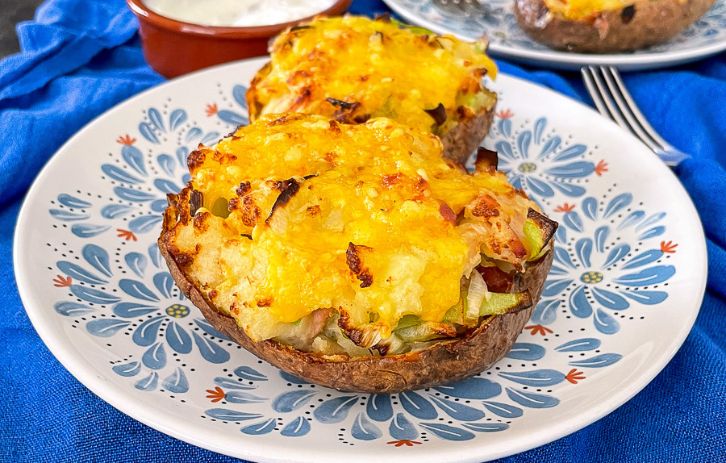 Air Fryer Loaded Potato Skins with Bacon and Leeks, topped with cheese, are incredible! Cheesy, tasty and super easy. Perfect with soured cream.