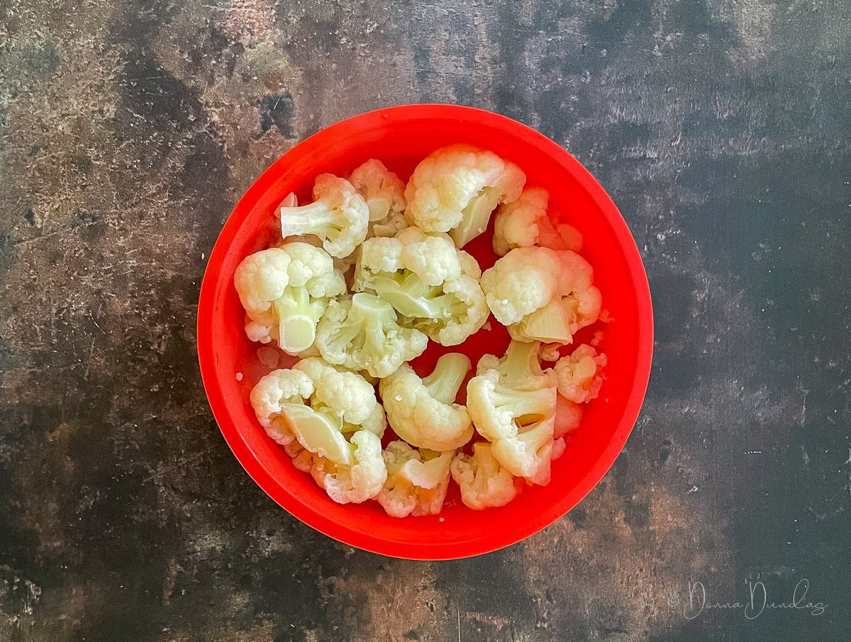 cooked cauliflower in red silicone mould.