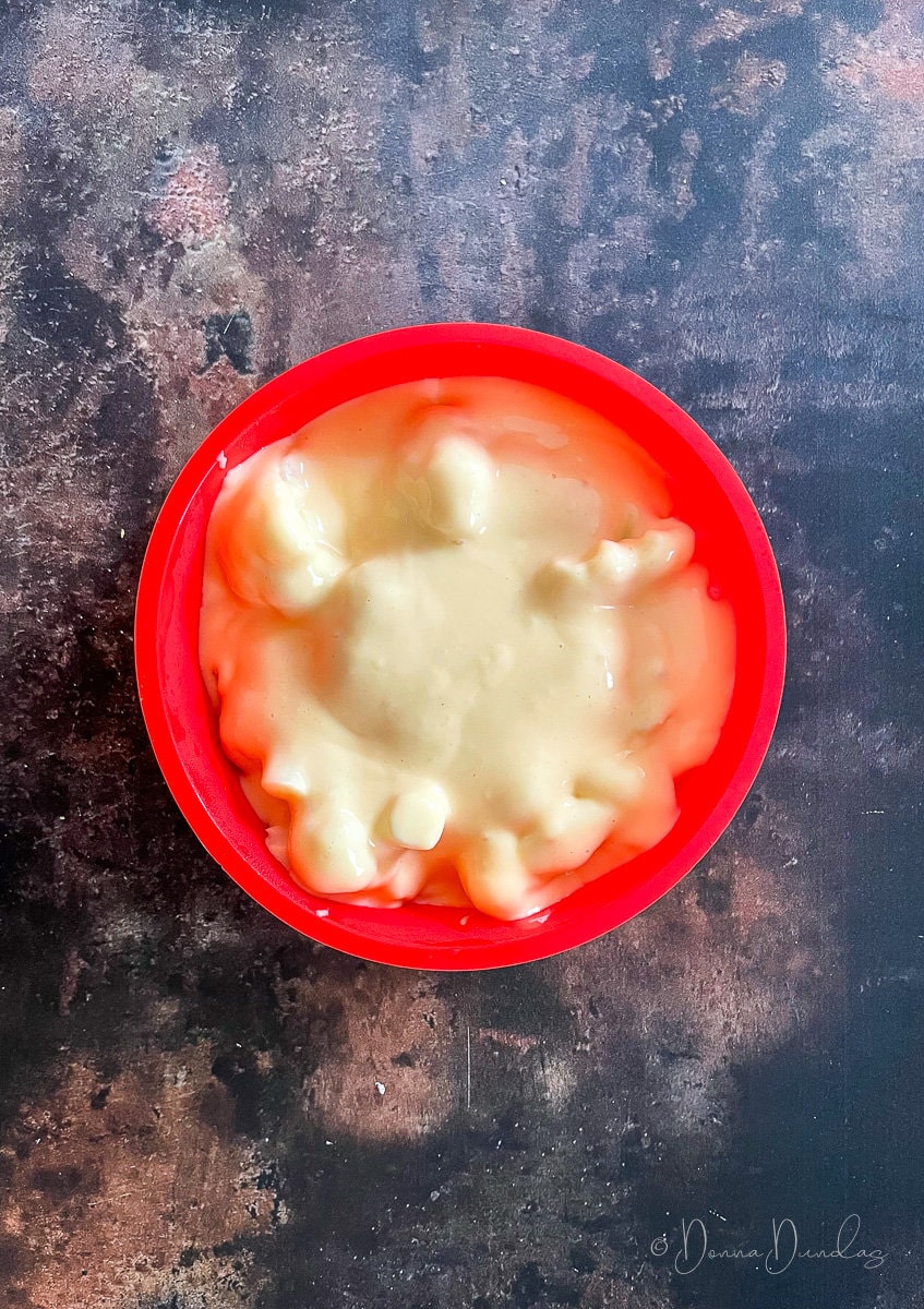 cauliflower in cheese sauce in red silicone mould.