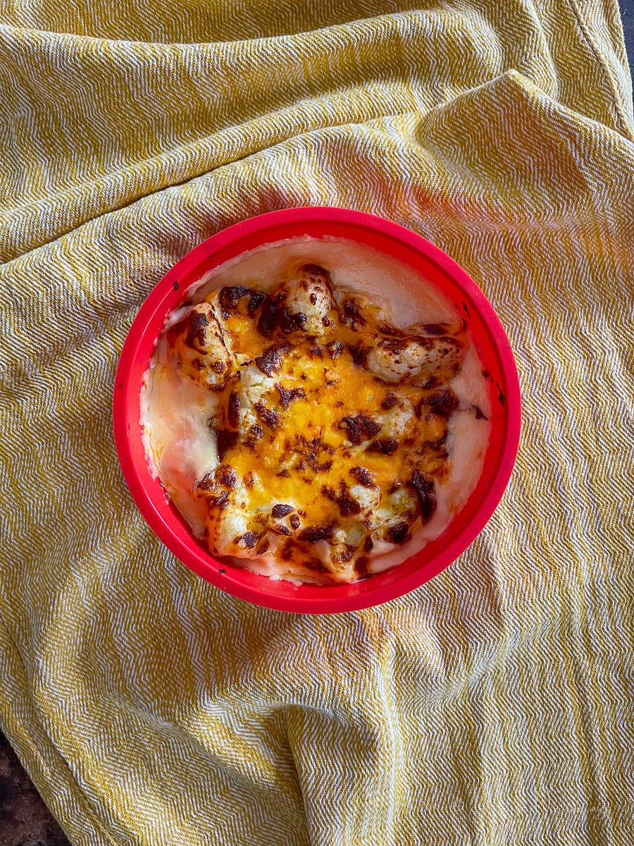 cauliflower cheese baked in a silicone dish.