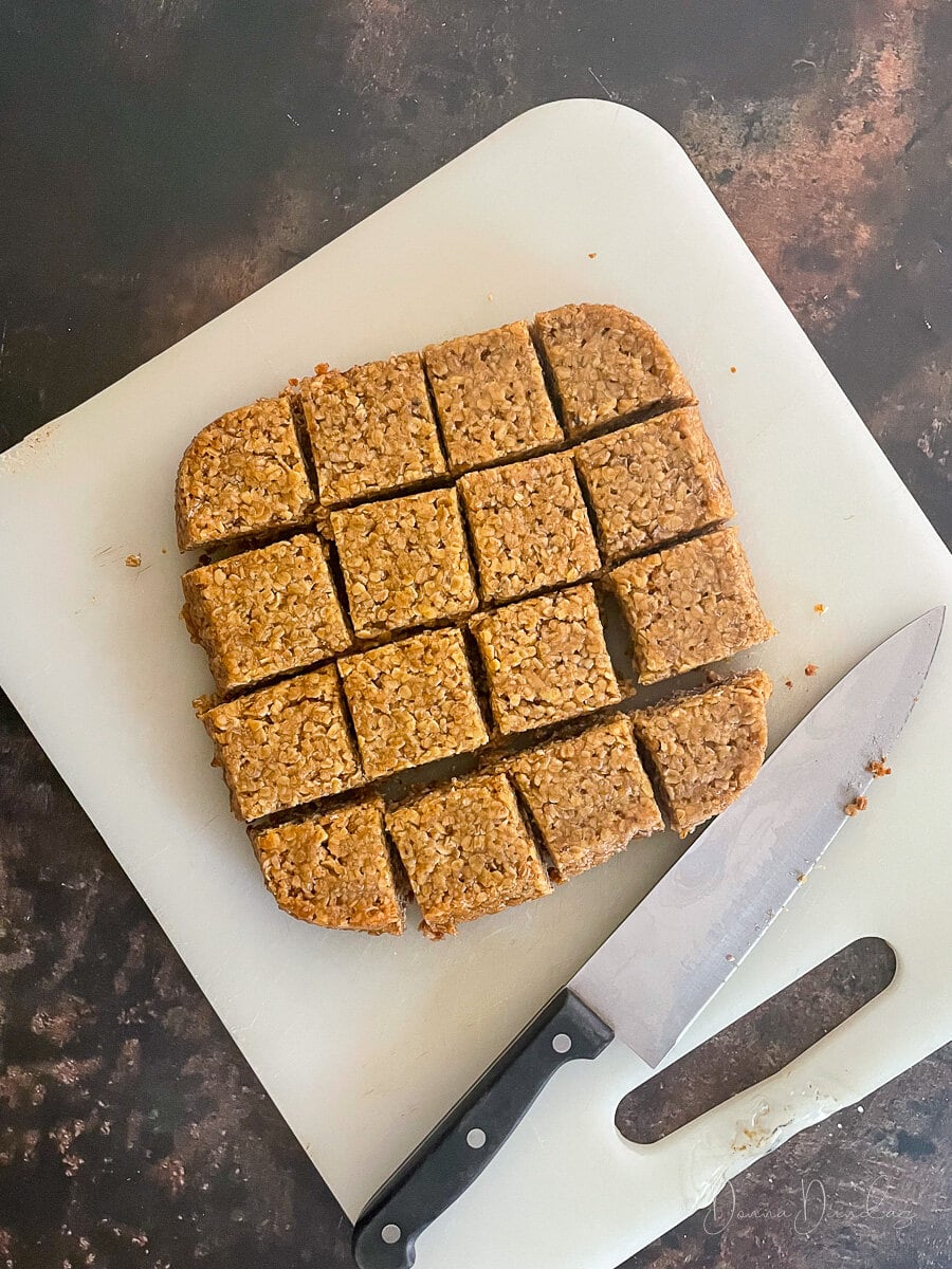 air fryer flapjack cut into squares on chopping board.