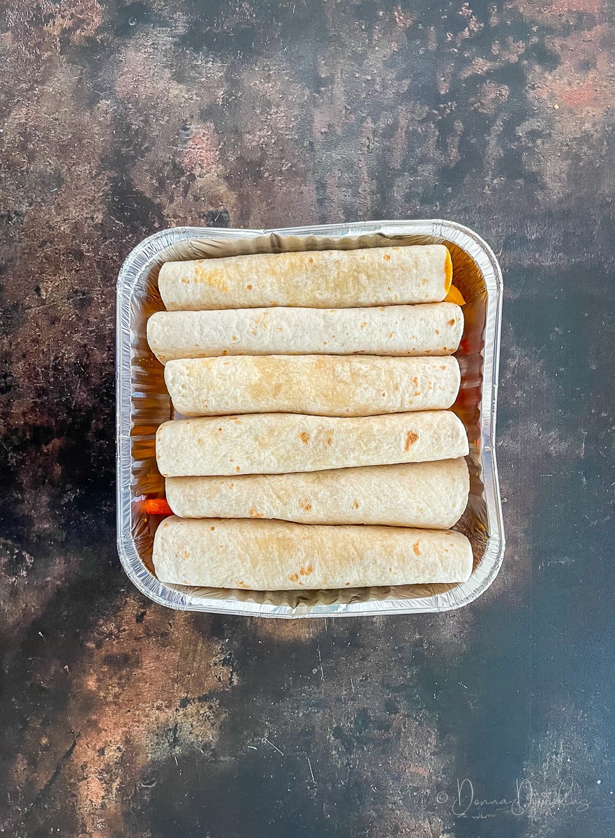 uncovered enciladas in tray.
