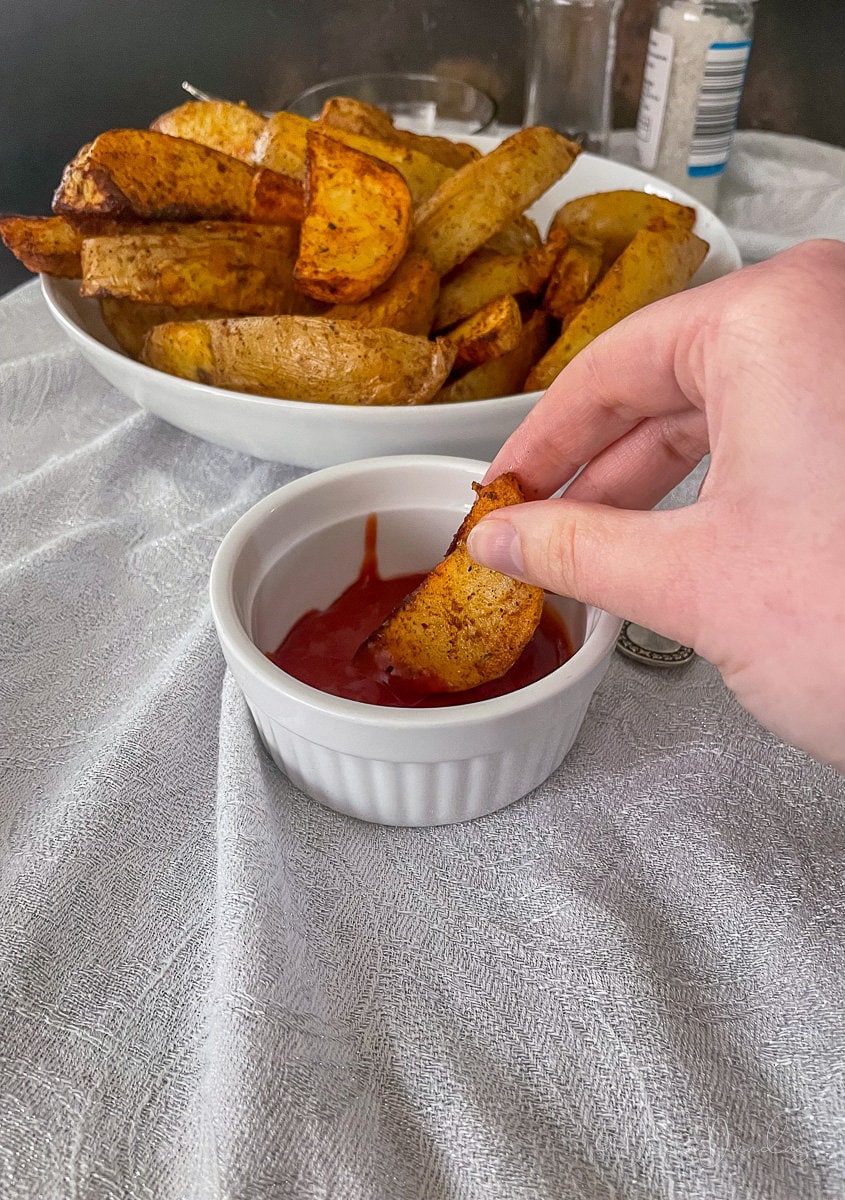 wedge being dipped in ketchup.