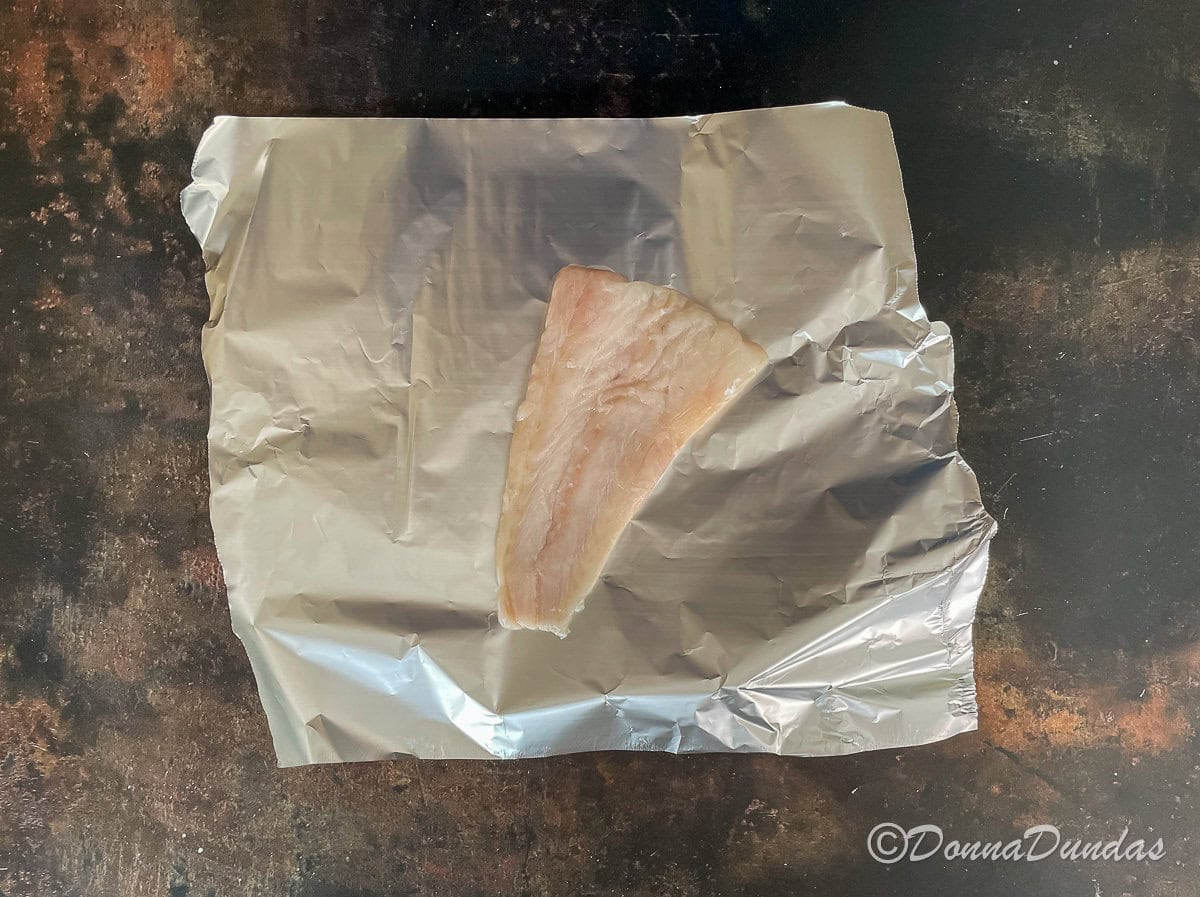 cod fillet on square of foil.