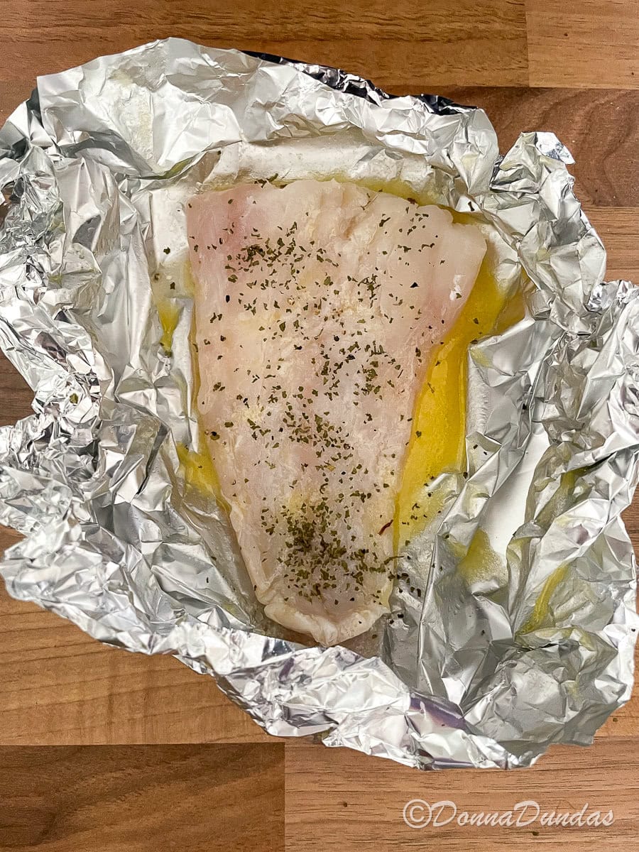 cod in foil with lemon butter, sprinkled in parsley and pepper.