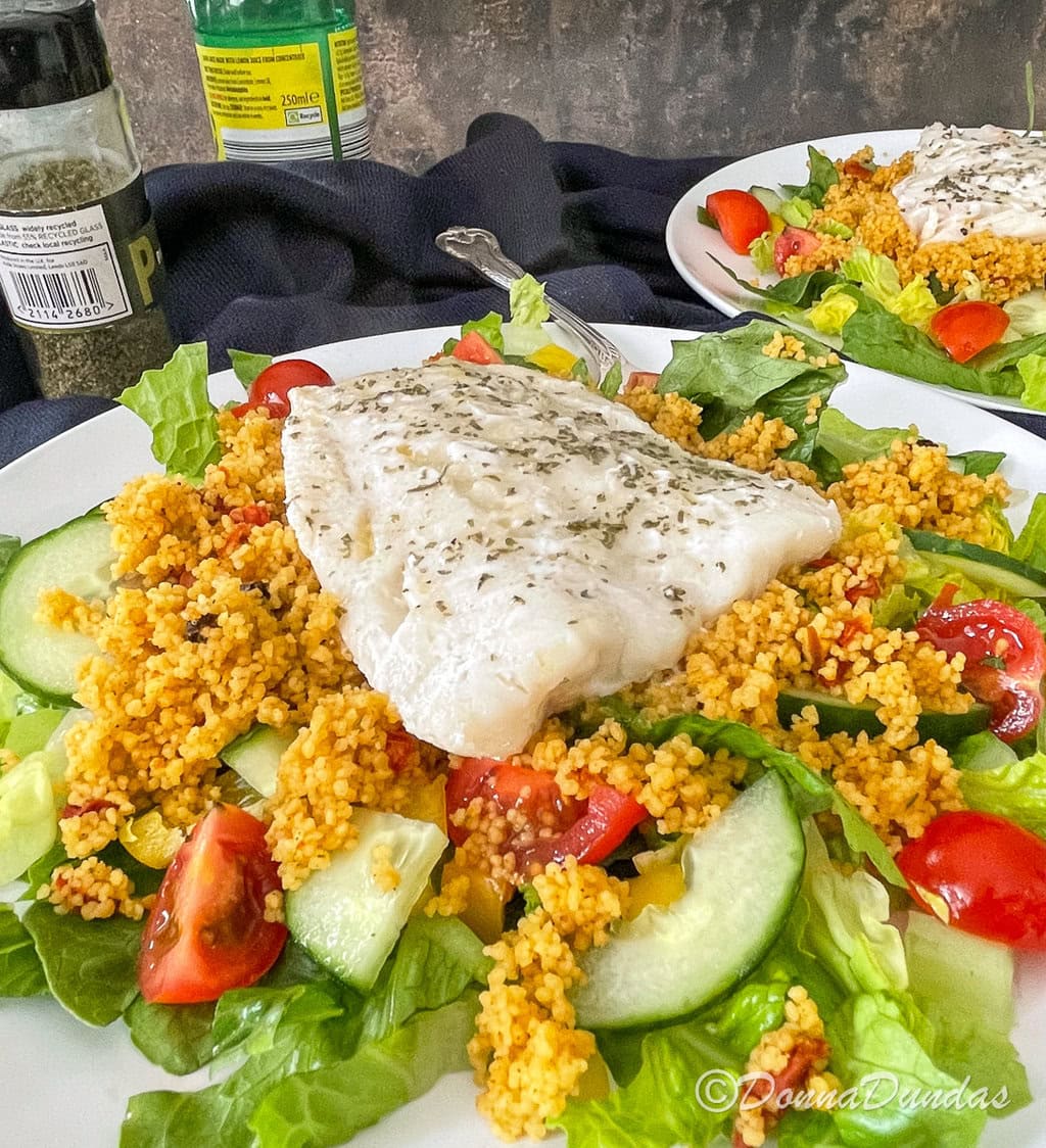close up of cod fillet with salad and couscous.