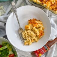 served portion of macaroni cheese in white bowl.