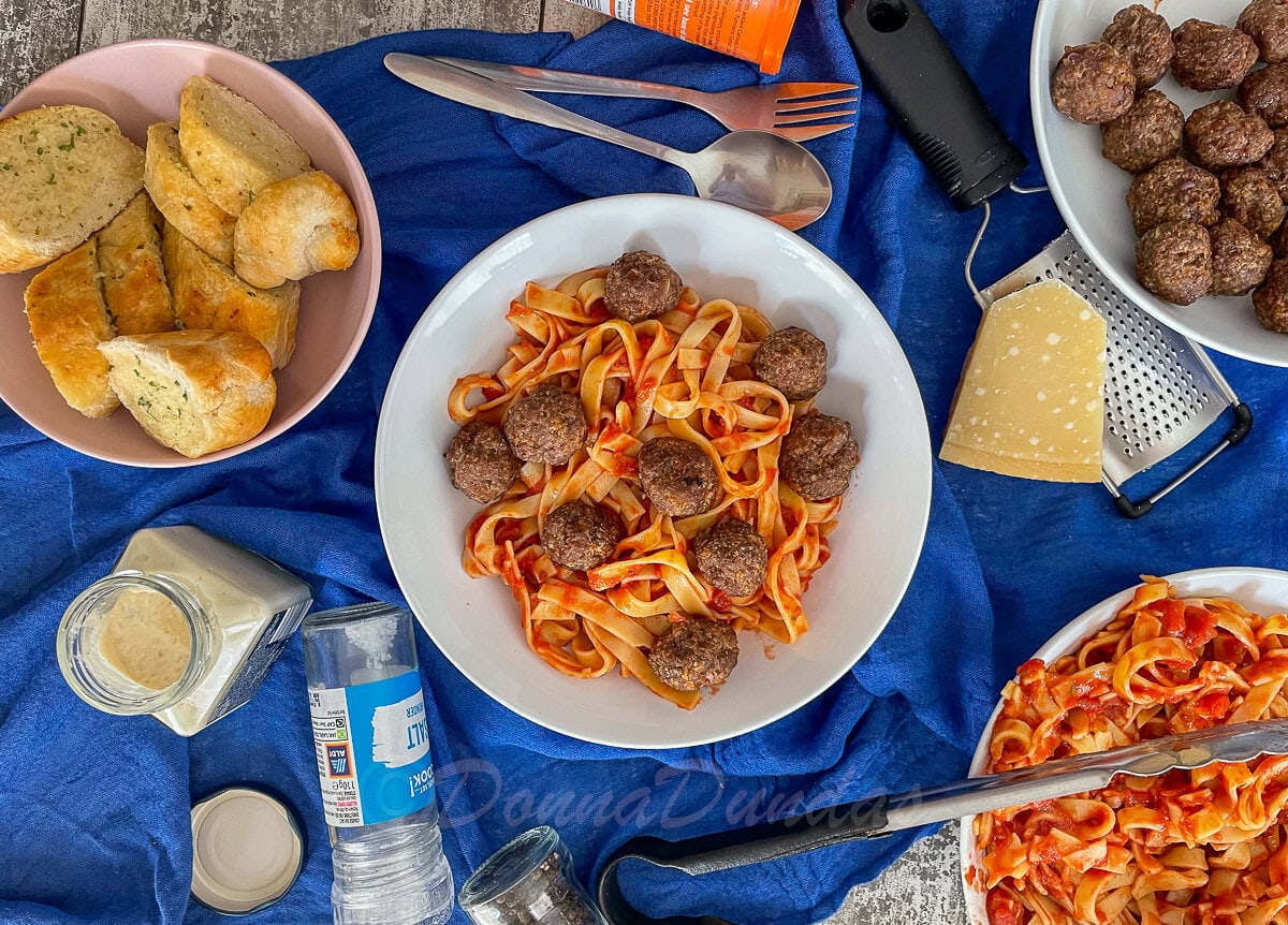 bowl of pasta and tomato sauce with air fryer meatballs.