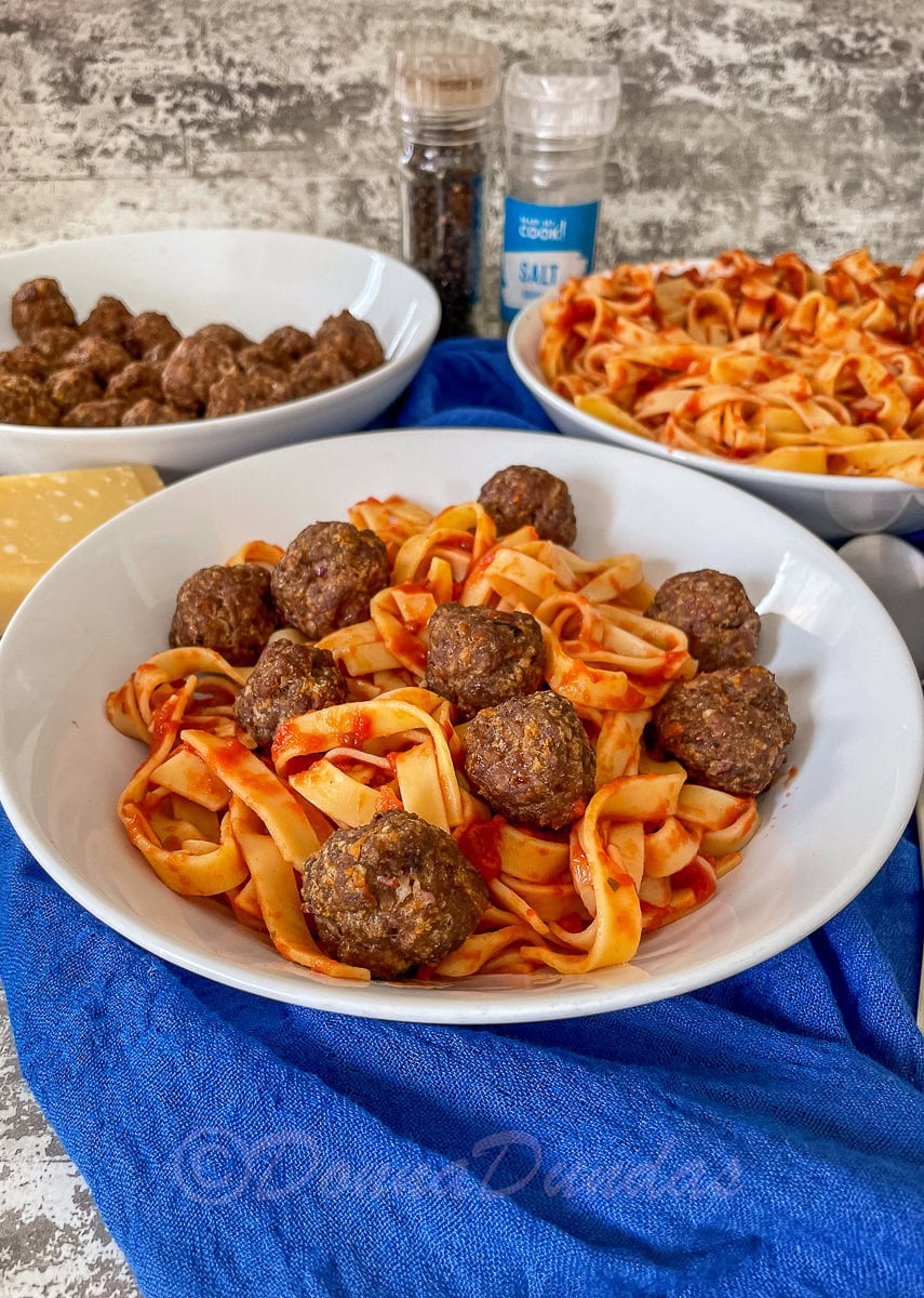 bowl of pasta and tomato sauce with air fryer meatballs.