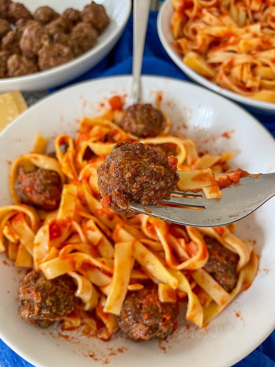 close up of meatball on fork.