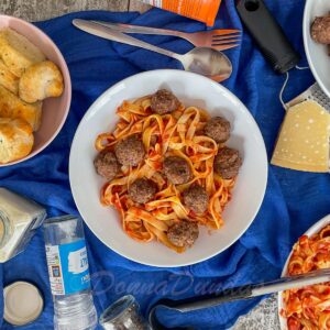 bowl of pasta and tomato sauce with air fryer meatballs.