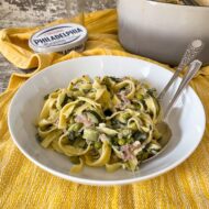 served bowl of tagliatelle with green veg.
