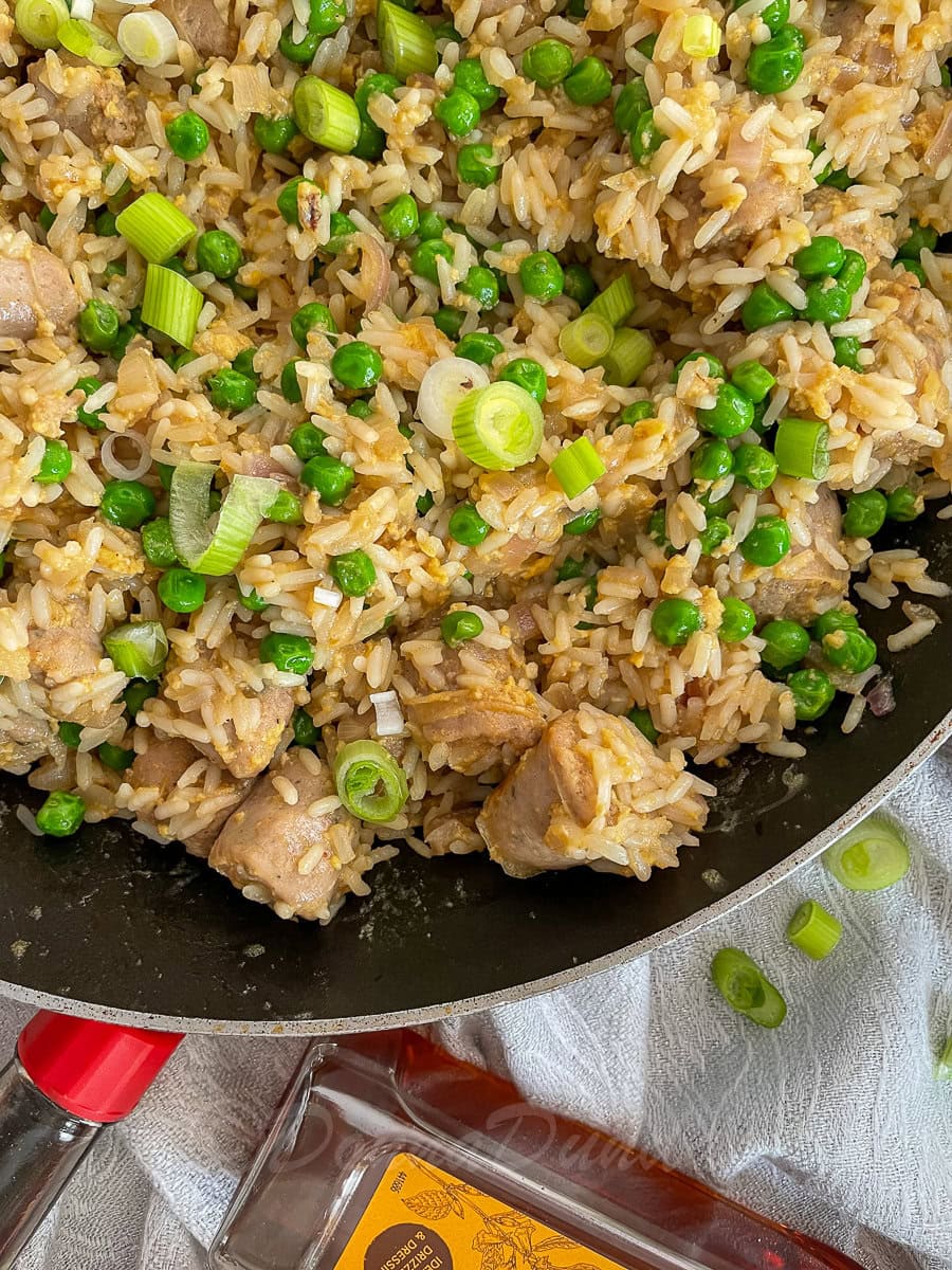 close up of sausage fried rice in frying pan.