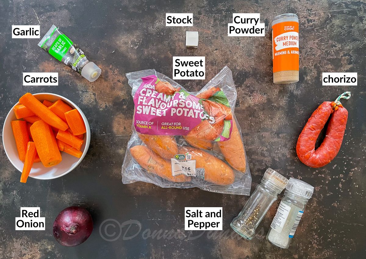 sweet potato and chorizo soup ingredients - carrots, garlic, stock, sweet potatoes, curry powder, chorizo, salt and pepper and red onion.