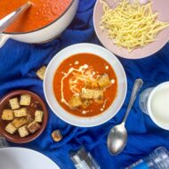 Red pepper soup topped with cream, gouda and grated cheese.