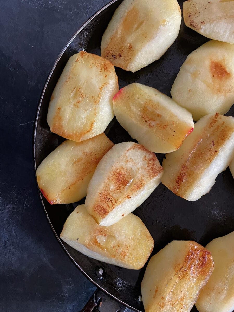 pan fried apples browning in pan.
