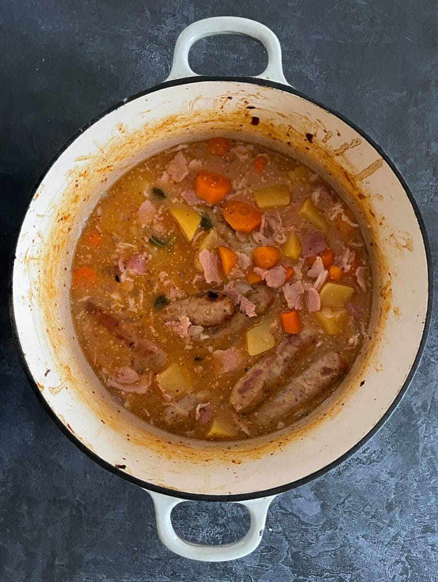 sausage casserole cooking in cast iron dish.