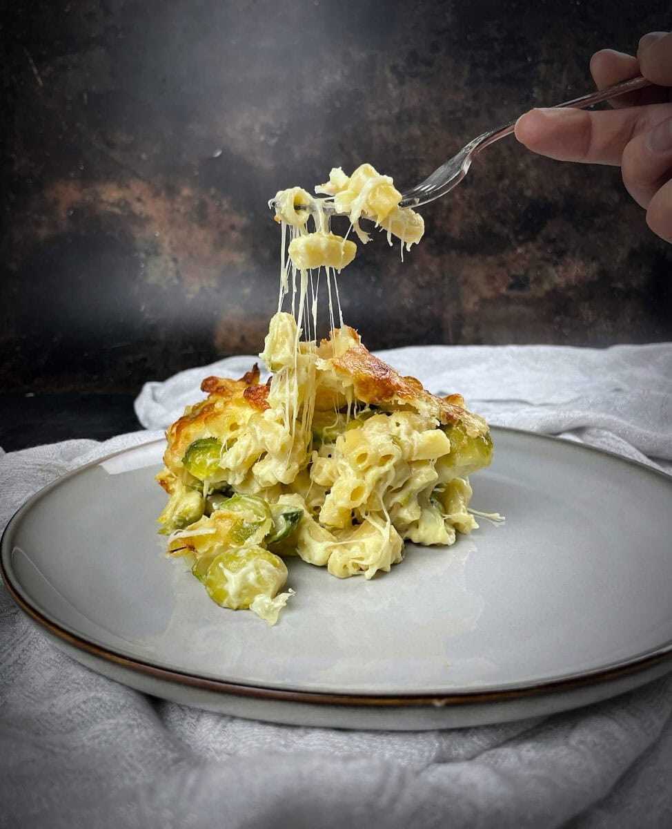 served portion of sprouts mac and cheese with cheese pull.