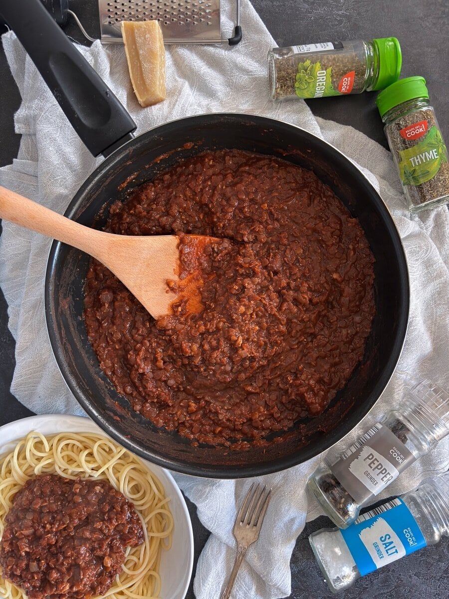 cooked vegetarian bolognese in pan. Served portion to the side.
