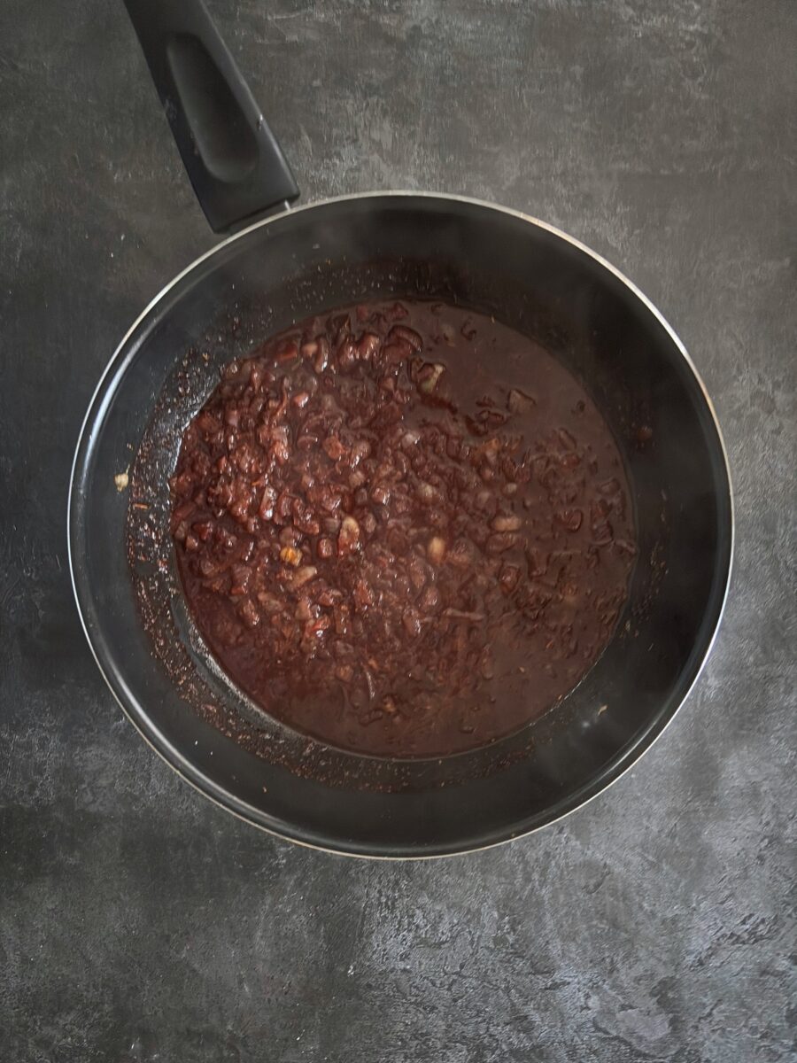 red wine bubbling in frying pan.